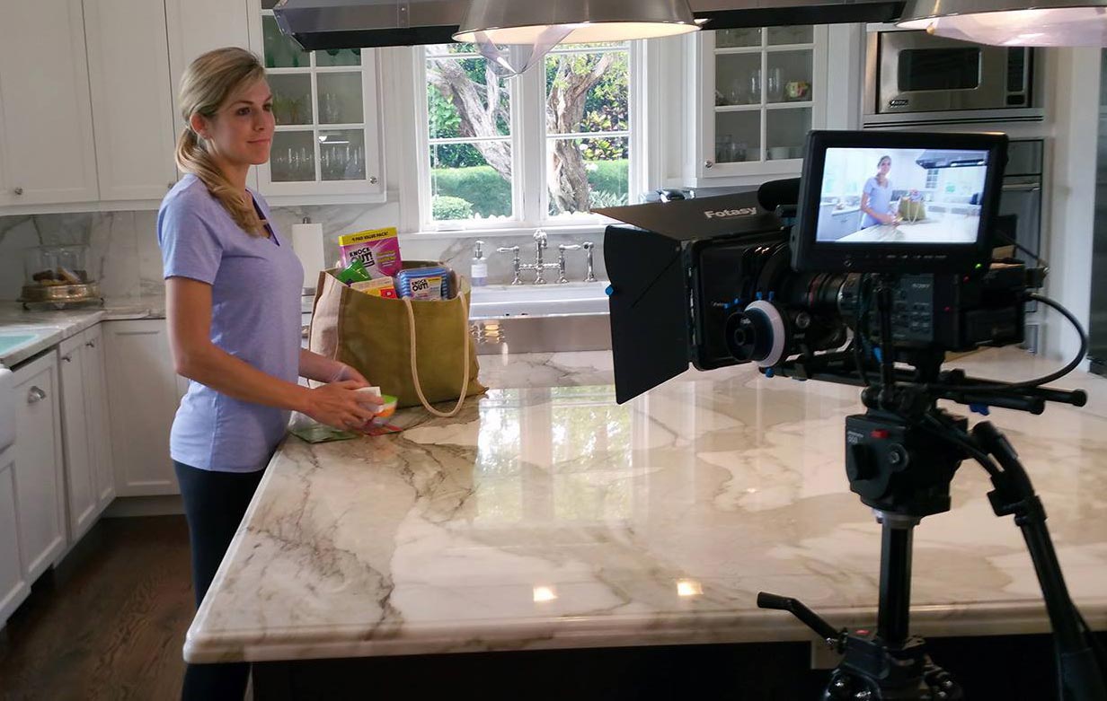 Woman being filmed in kitchen for commercial by Awecast