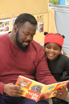 Community Action Pioneer Valley member reading to child