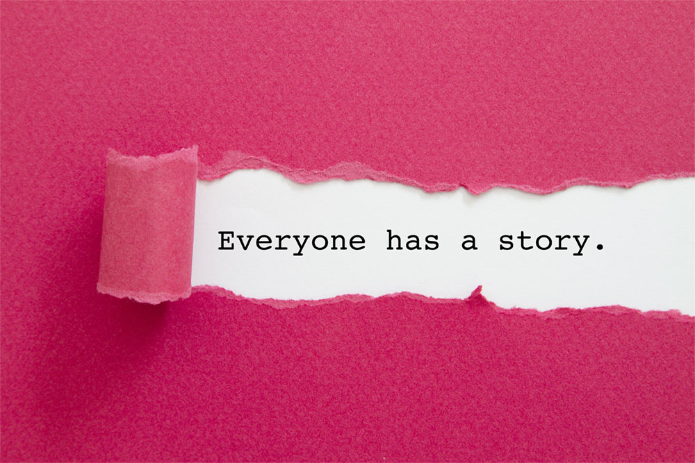 Pink wallpaper peeling away revealing "Everyone has a story."