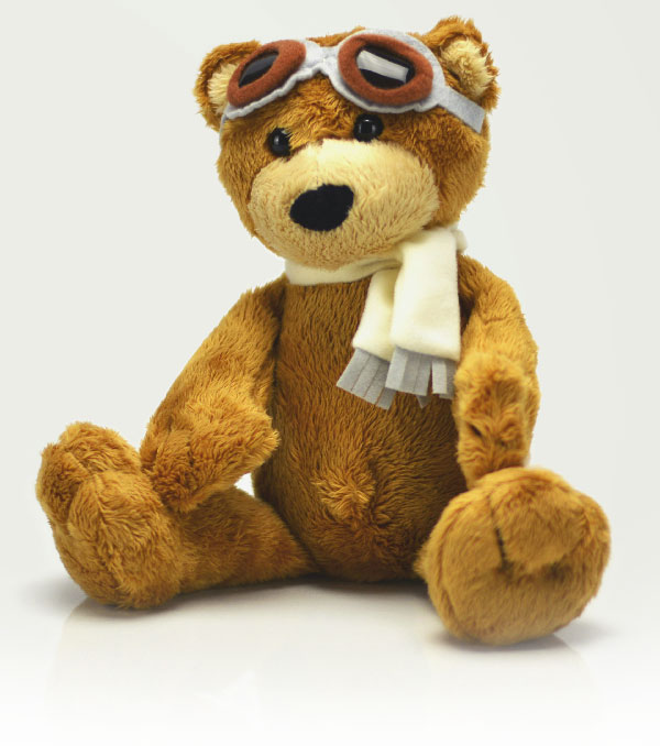 Teddy Bear sitting with goggles on his head.