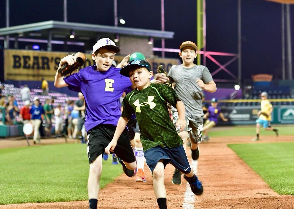 Kids running the bases at Dunkin Donuts park